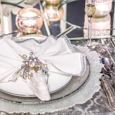White and silver place setting on a winter tablescape