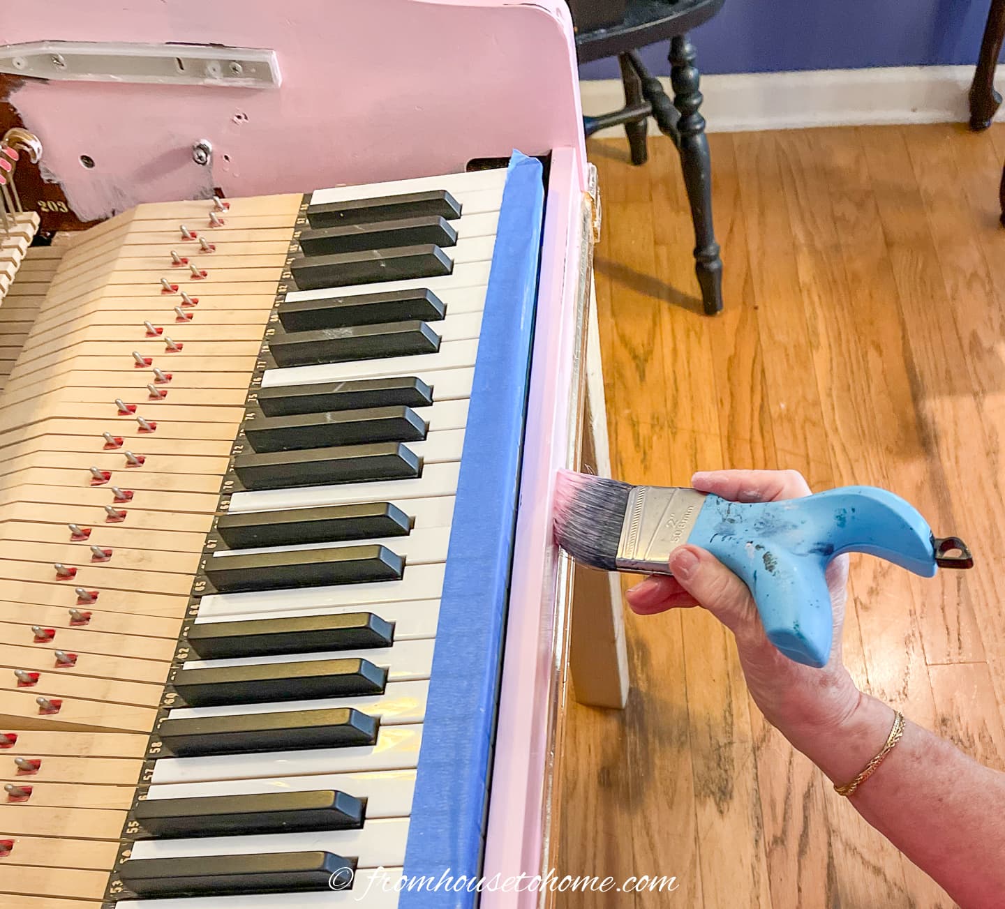 Piano being painted with a brush
