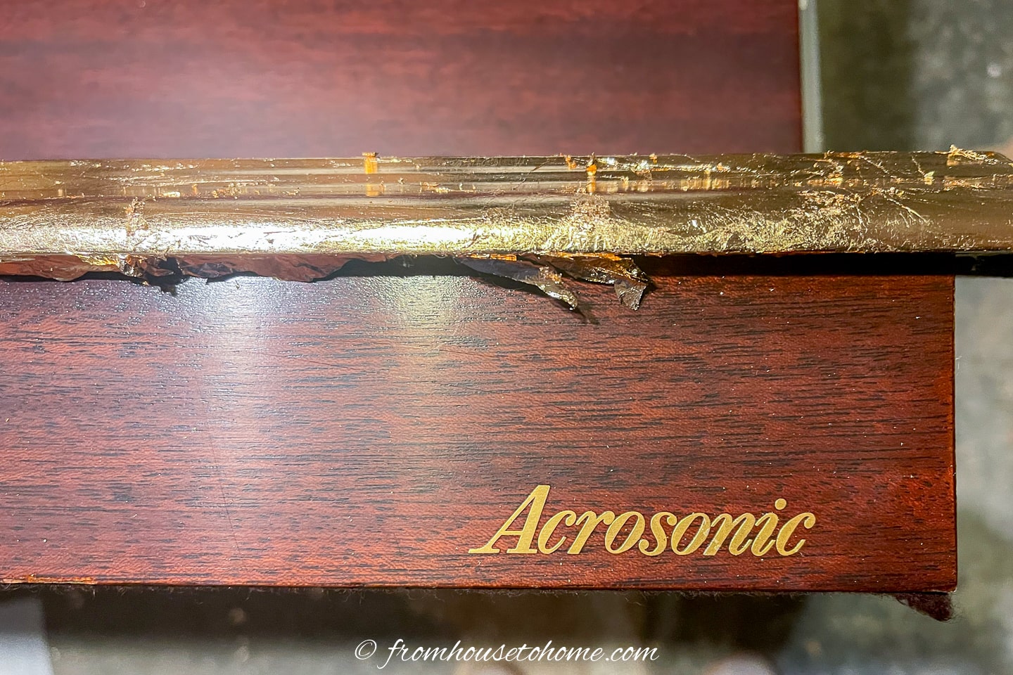Excess gold foil on the front of a piano