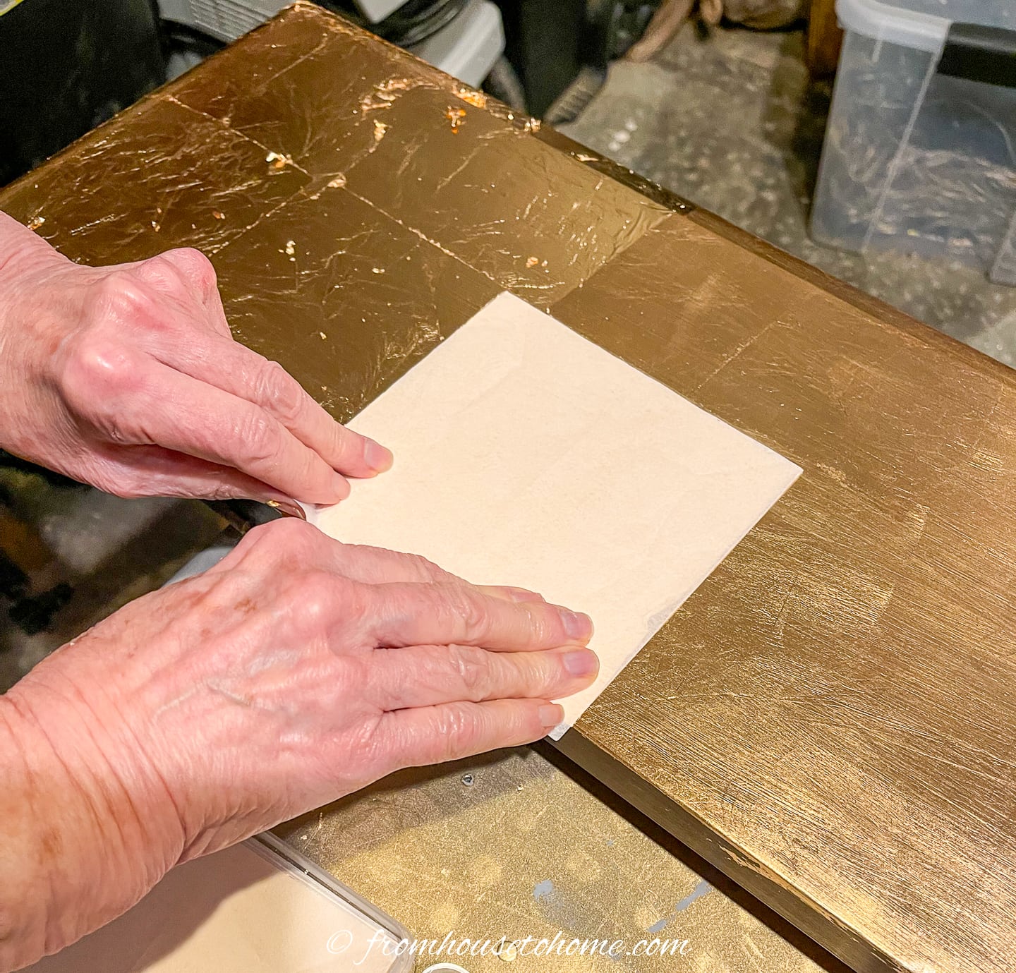 Gold leaf being applied to a piano
