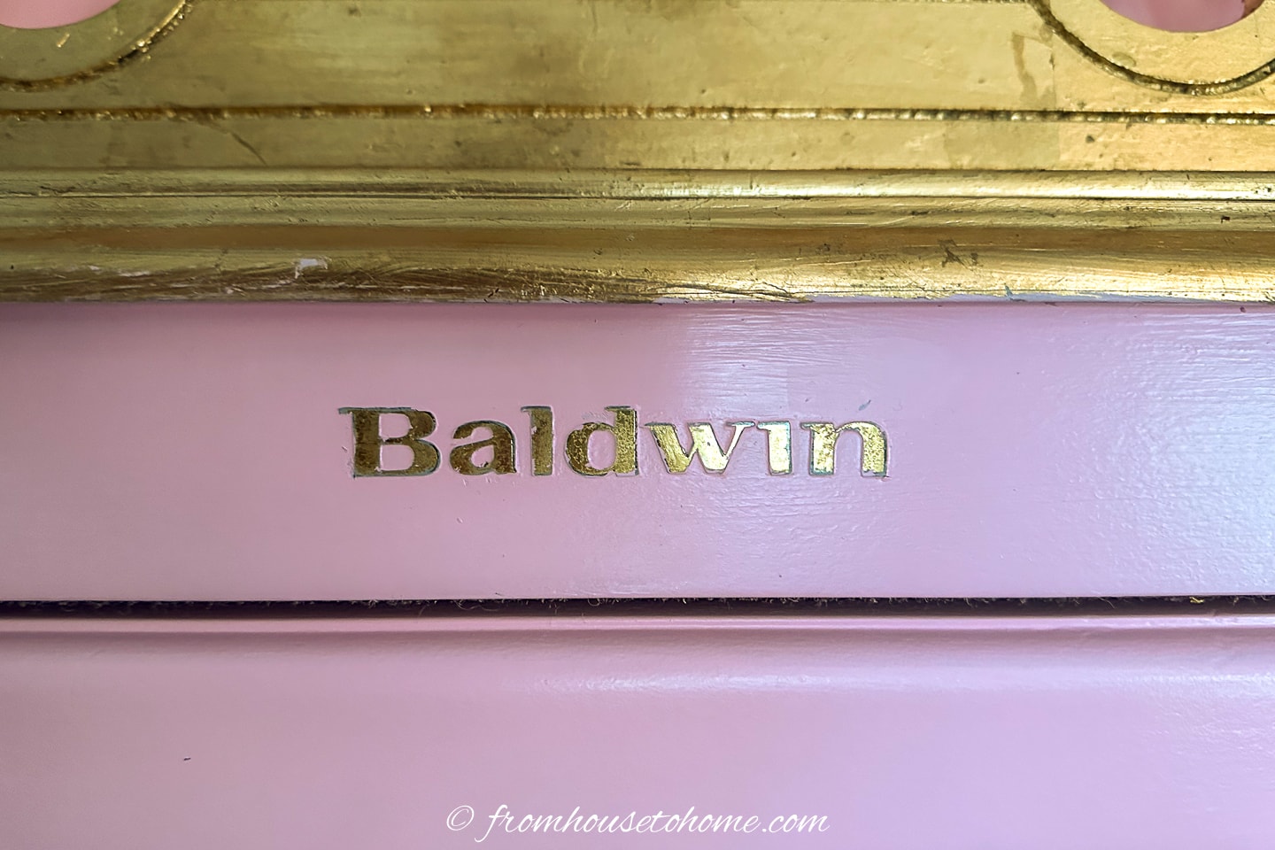 Close up of Baldwin brand name after the paint has been removed for it