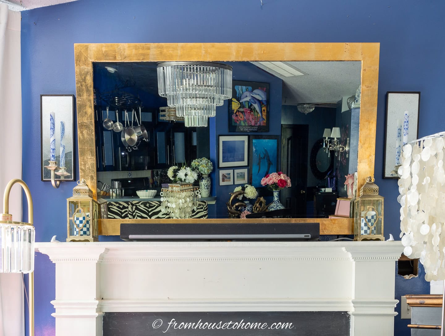 Mirror TV hung over a fireplace mantel