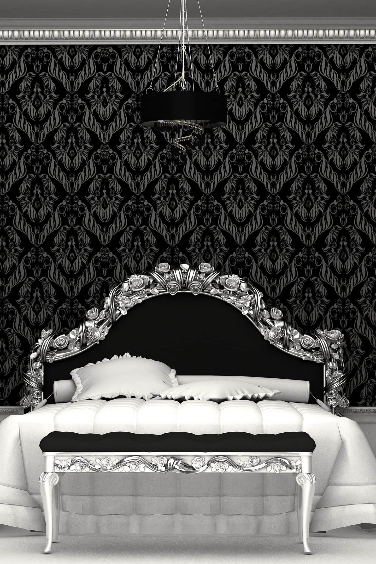 Black, white and silver bed in a bedroom with black wallpaper