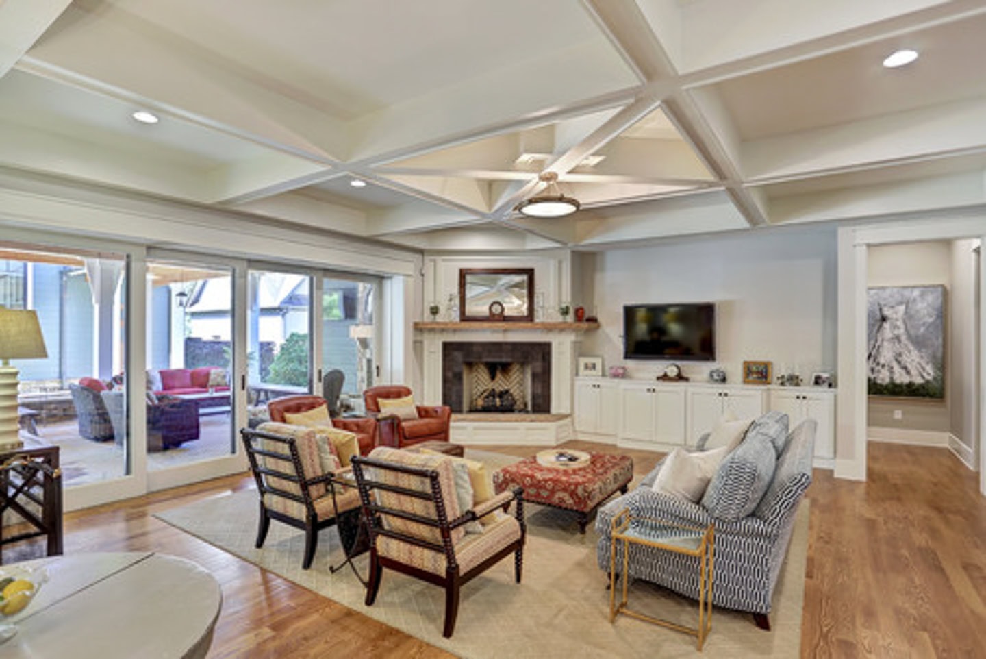 A living room with multiple chairs arranged in front of a corner fireplace