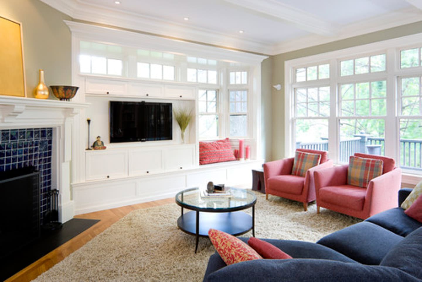 A area rug with the corner cut to fit in front of an angled fireplace in a living room