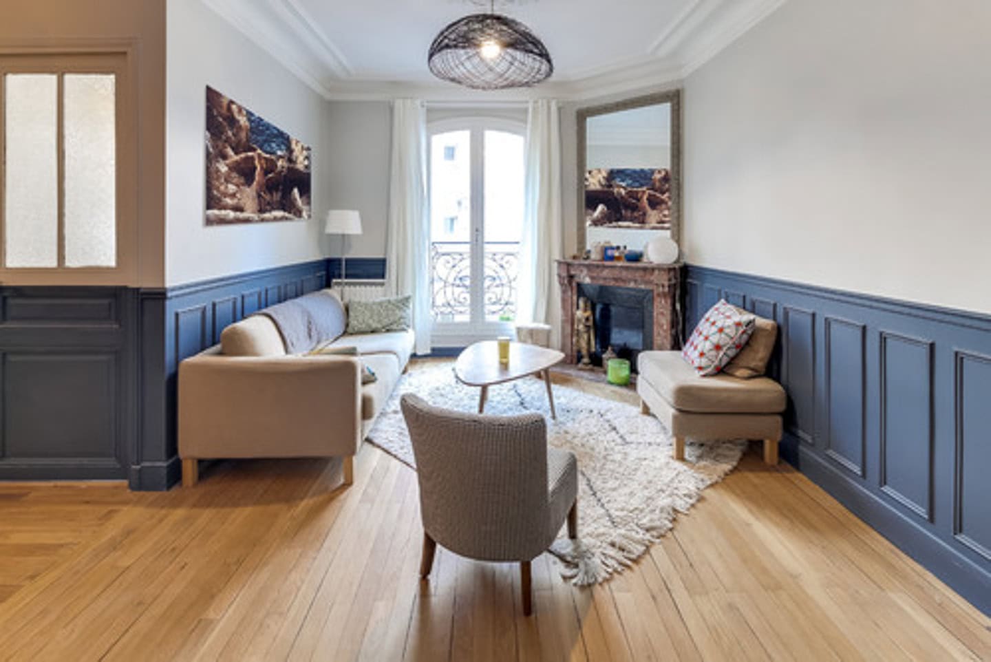 A small living room with an angled fireplace