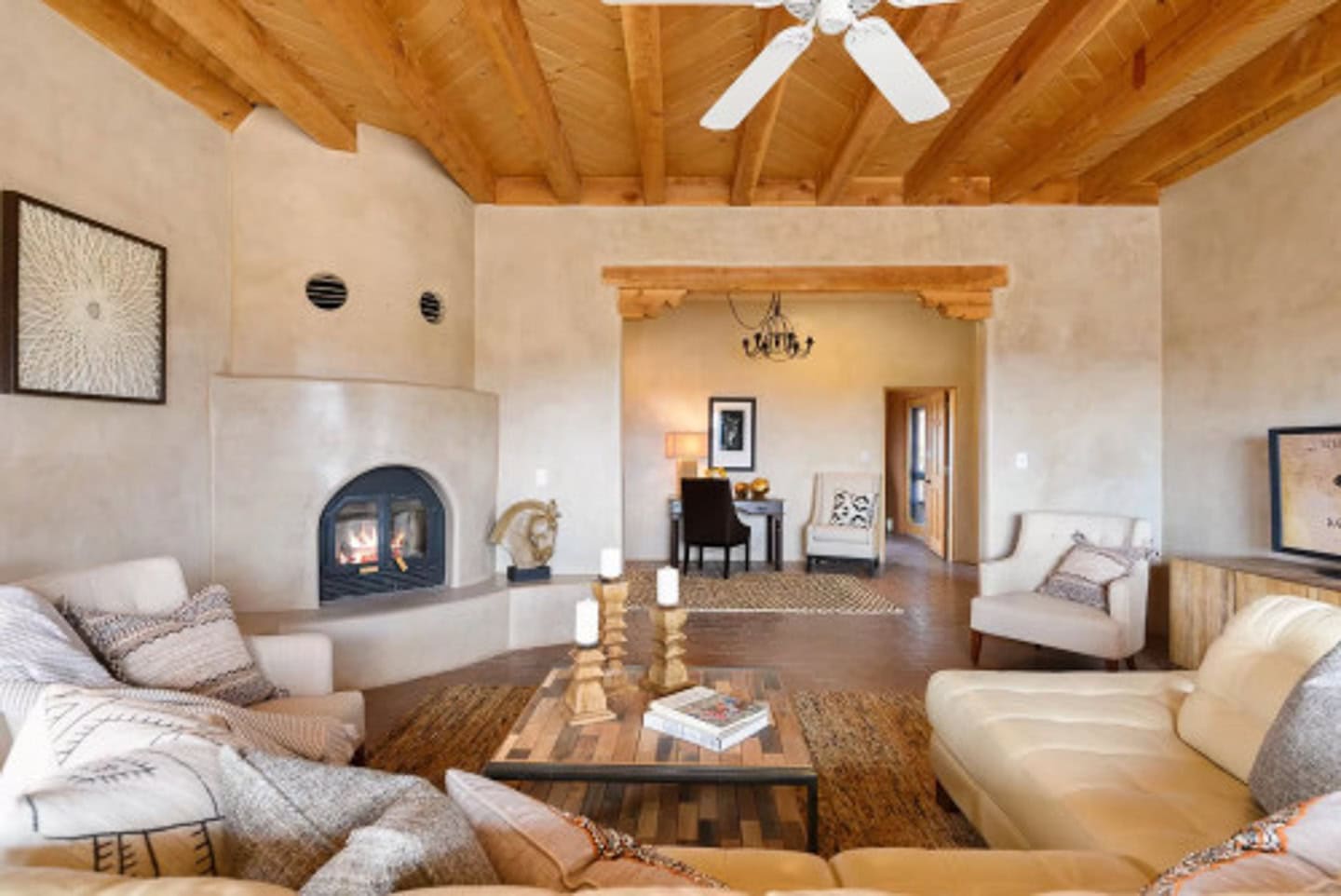 A U-shaped conversation area beside a corner fireplace