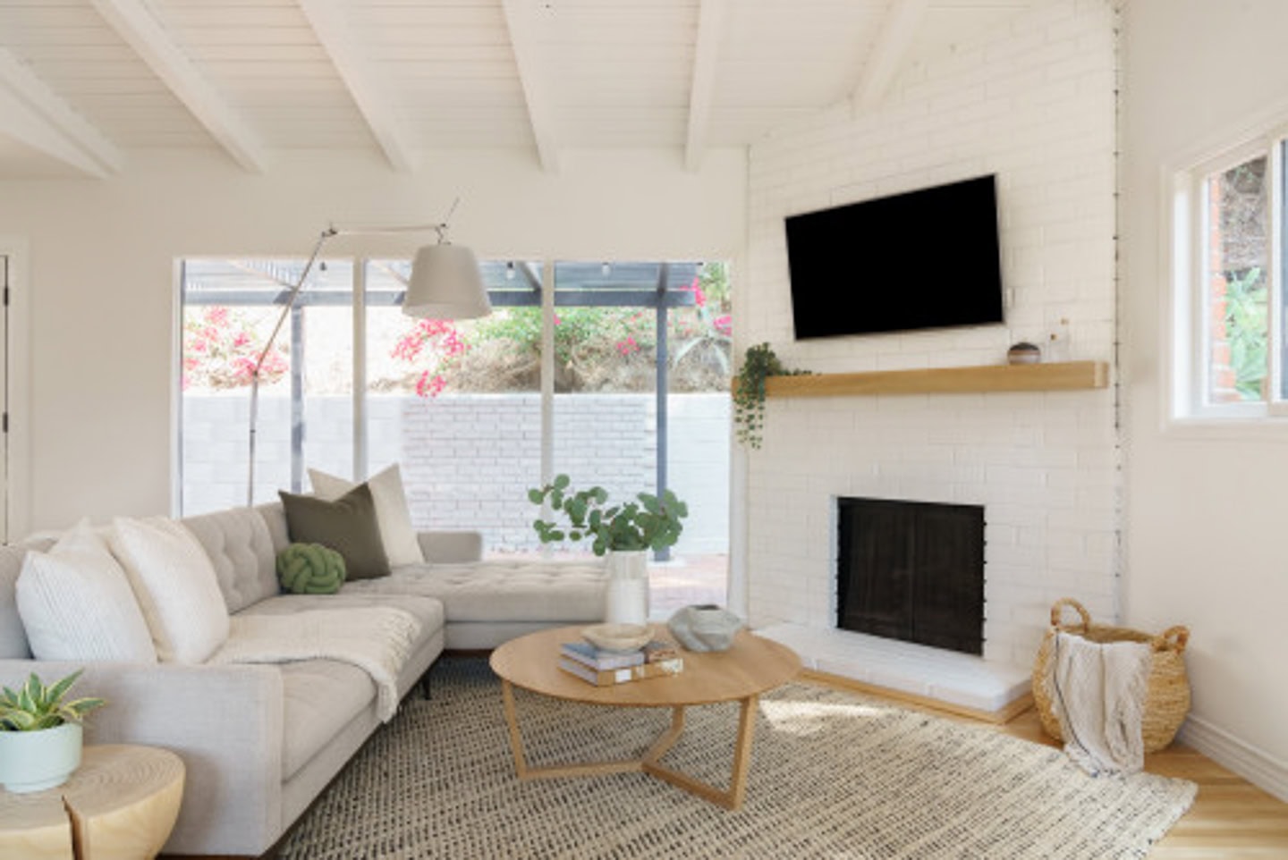 small living room with a small sectional facing an angled fireplace