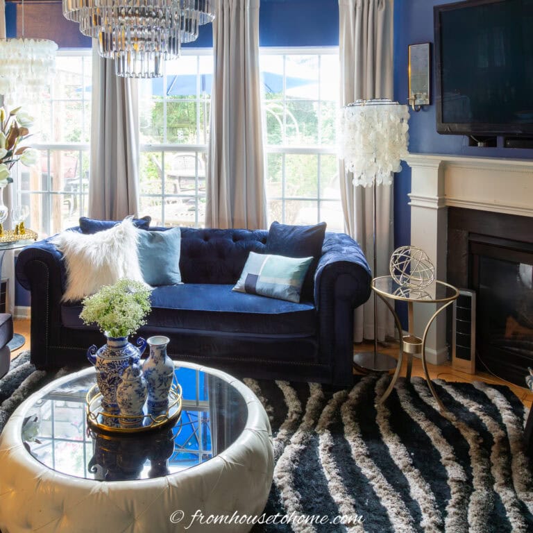 living room with an angled fireplace and a sofa on the wall beside it