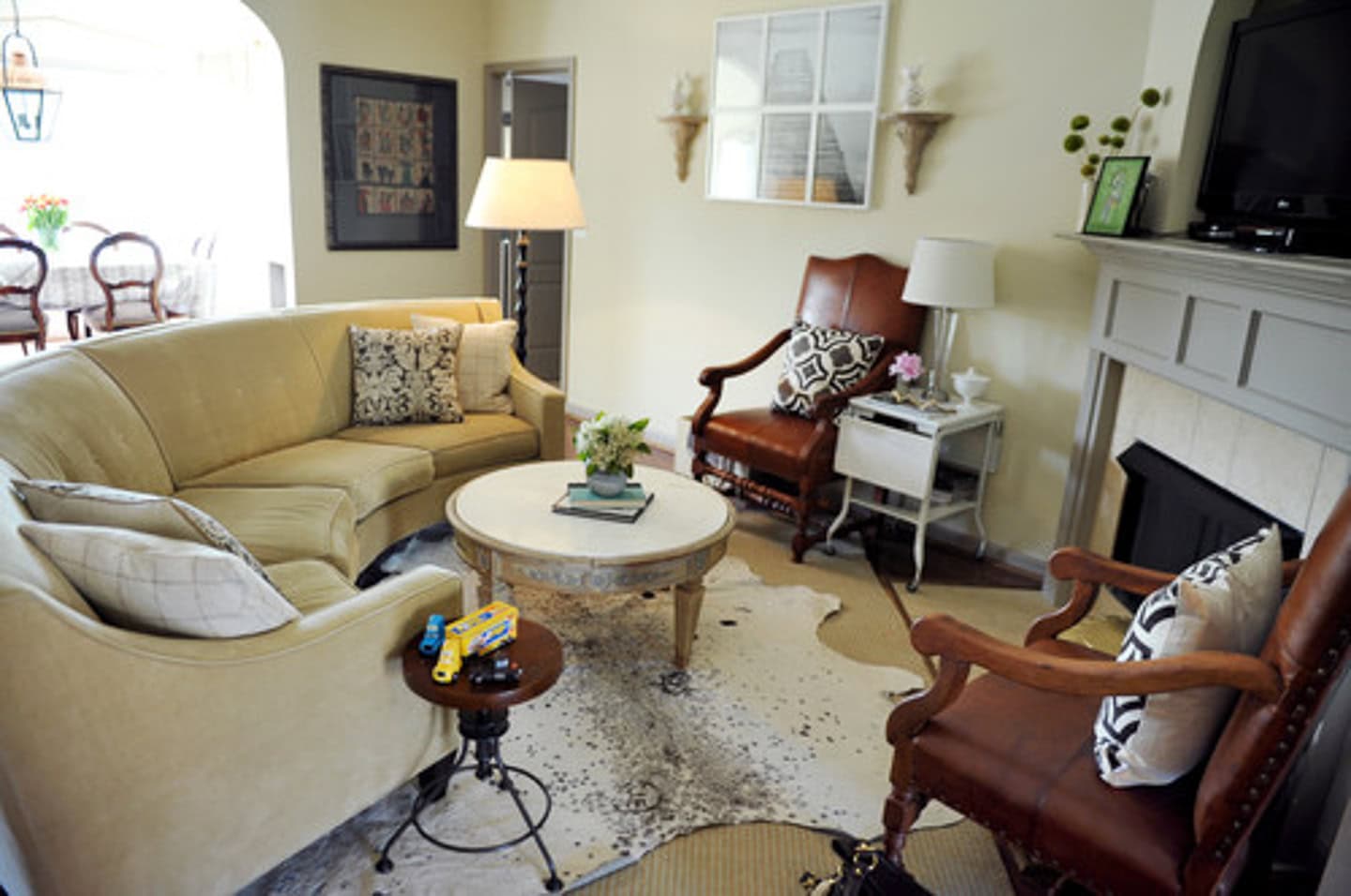 A curved sofa in front of an angled fireplace