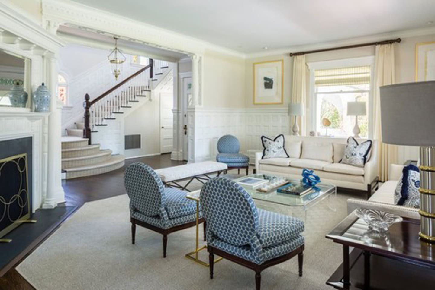A conversation area set up in a living room with an angled fireplace in the background