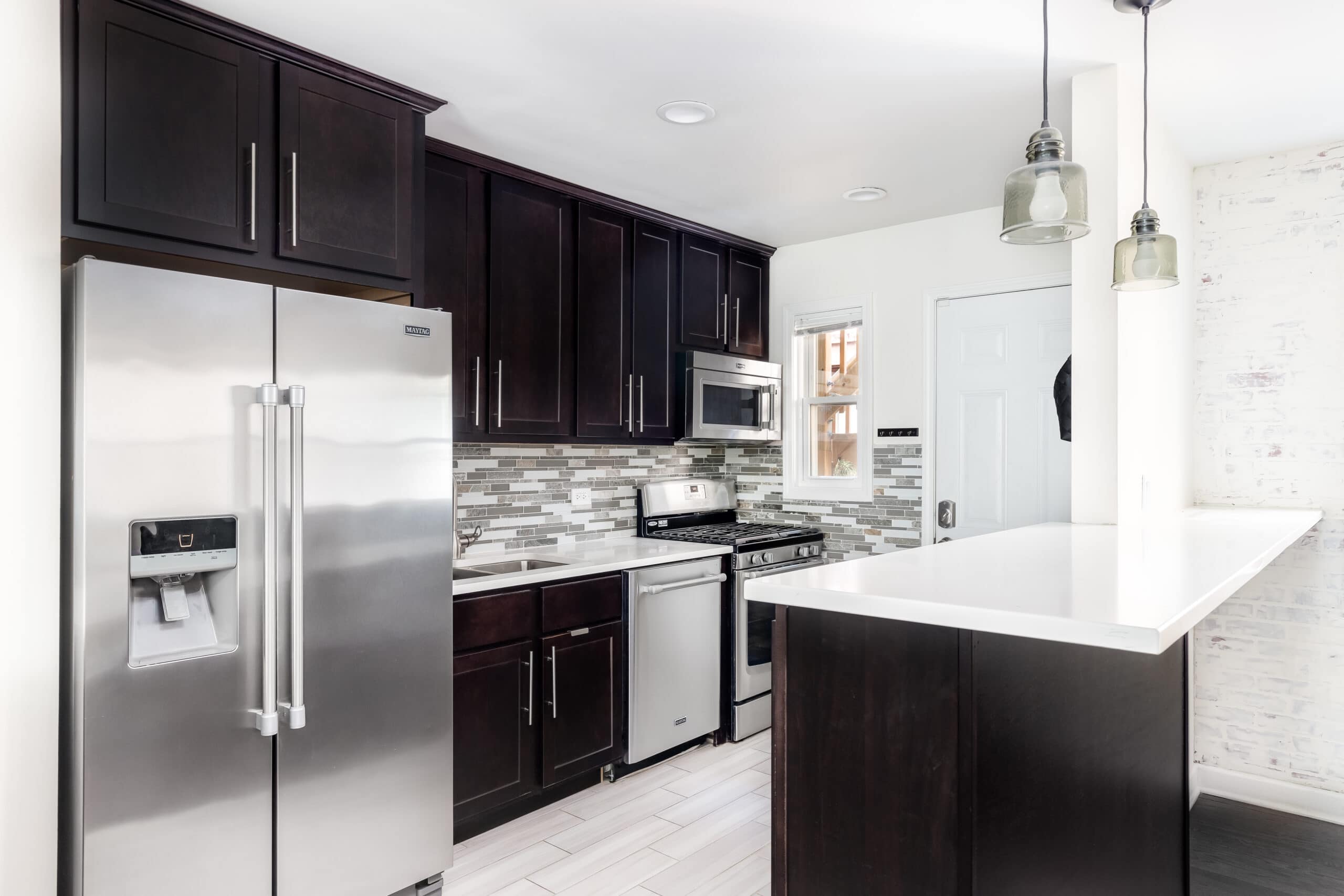 black and white kitchen with stainless appliances
