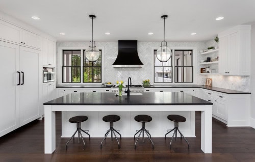 traditional white kitchen with a black countertop