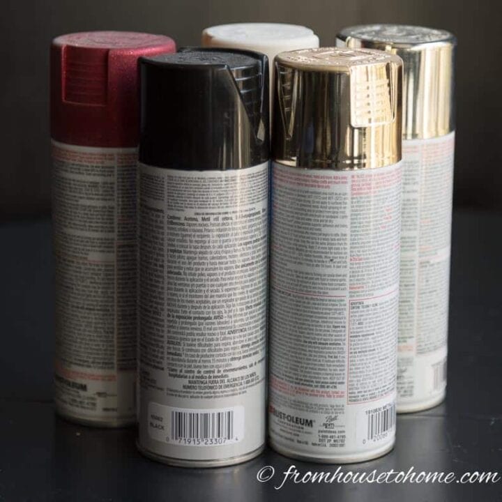 a group of 5 spray paint cans