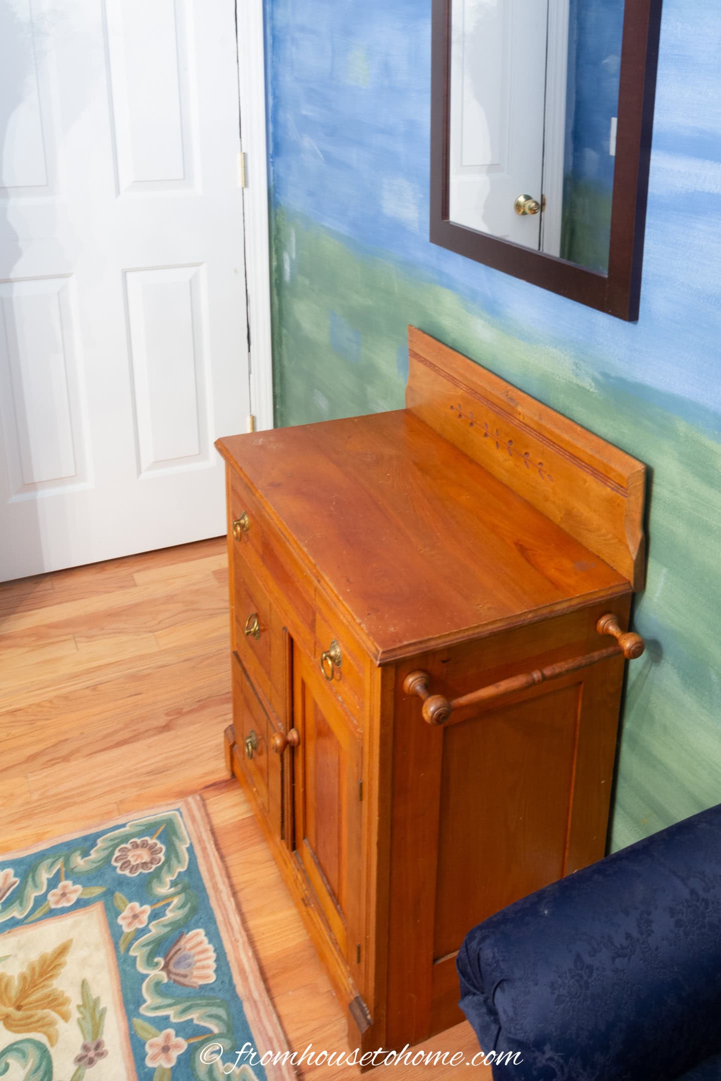 An antique washstand used as a dresser in a guest bedroom
