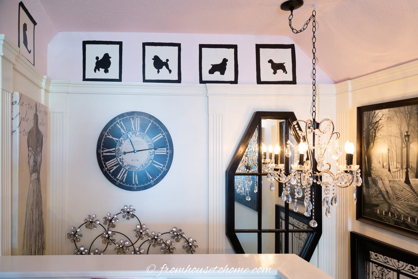 A stairwell gallery wall with DIY black and white silhouette pictures at the top