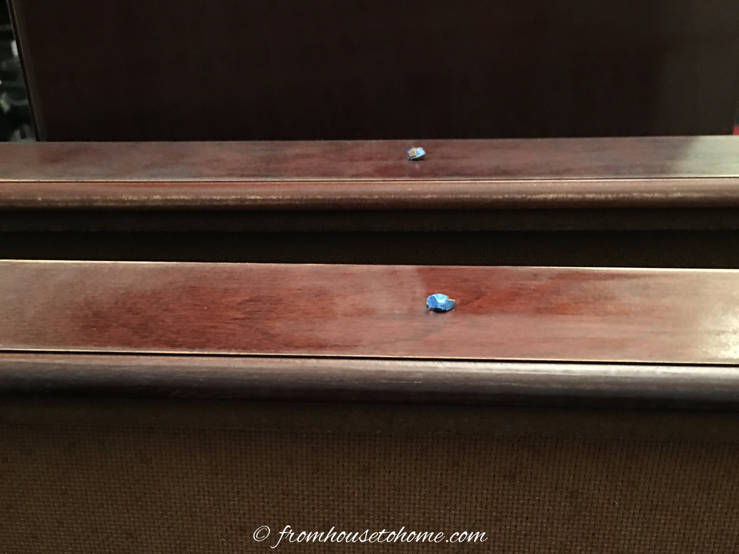 Nightstand drawers with knobs covered with painters tape.