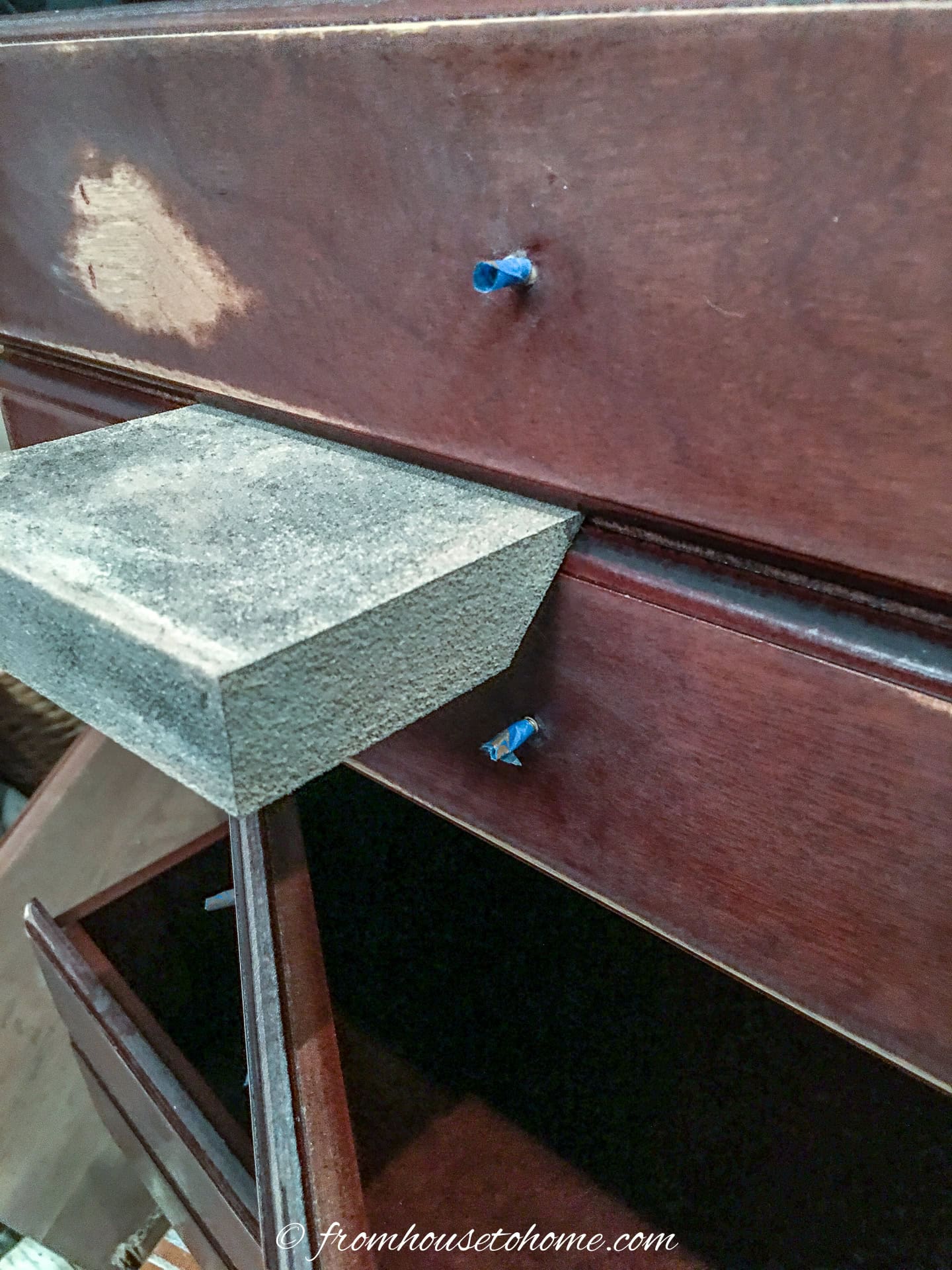 a sanding block being used to sand grooves in the nightstand