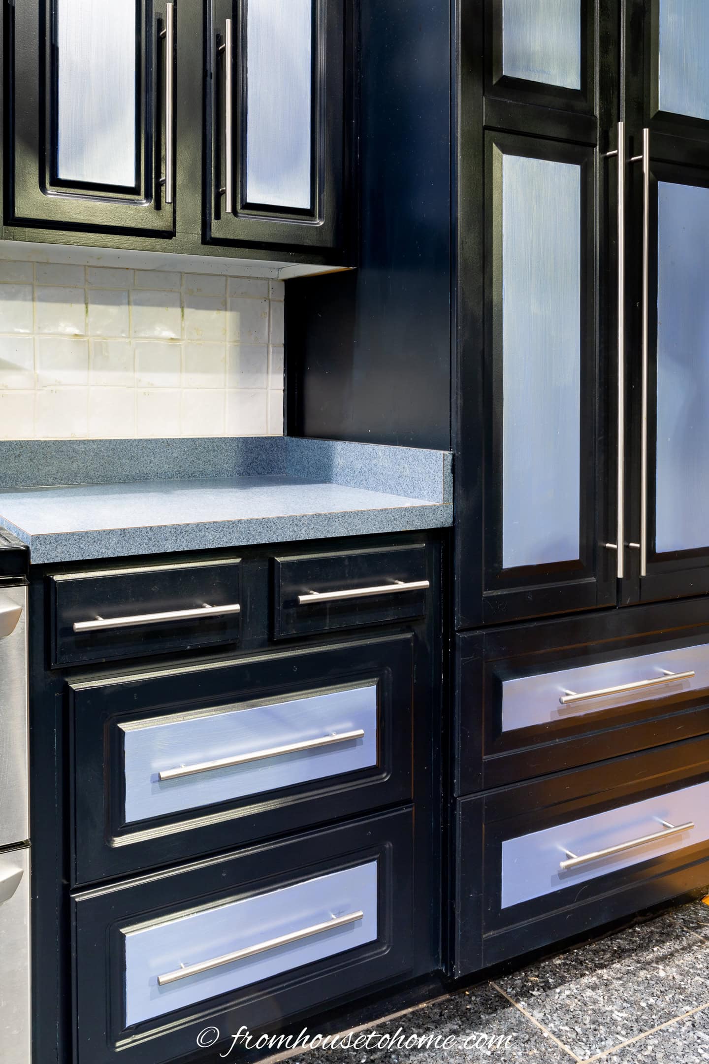 Melamine kitchen cabinets painted with black and blue paint