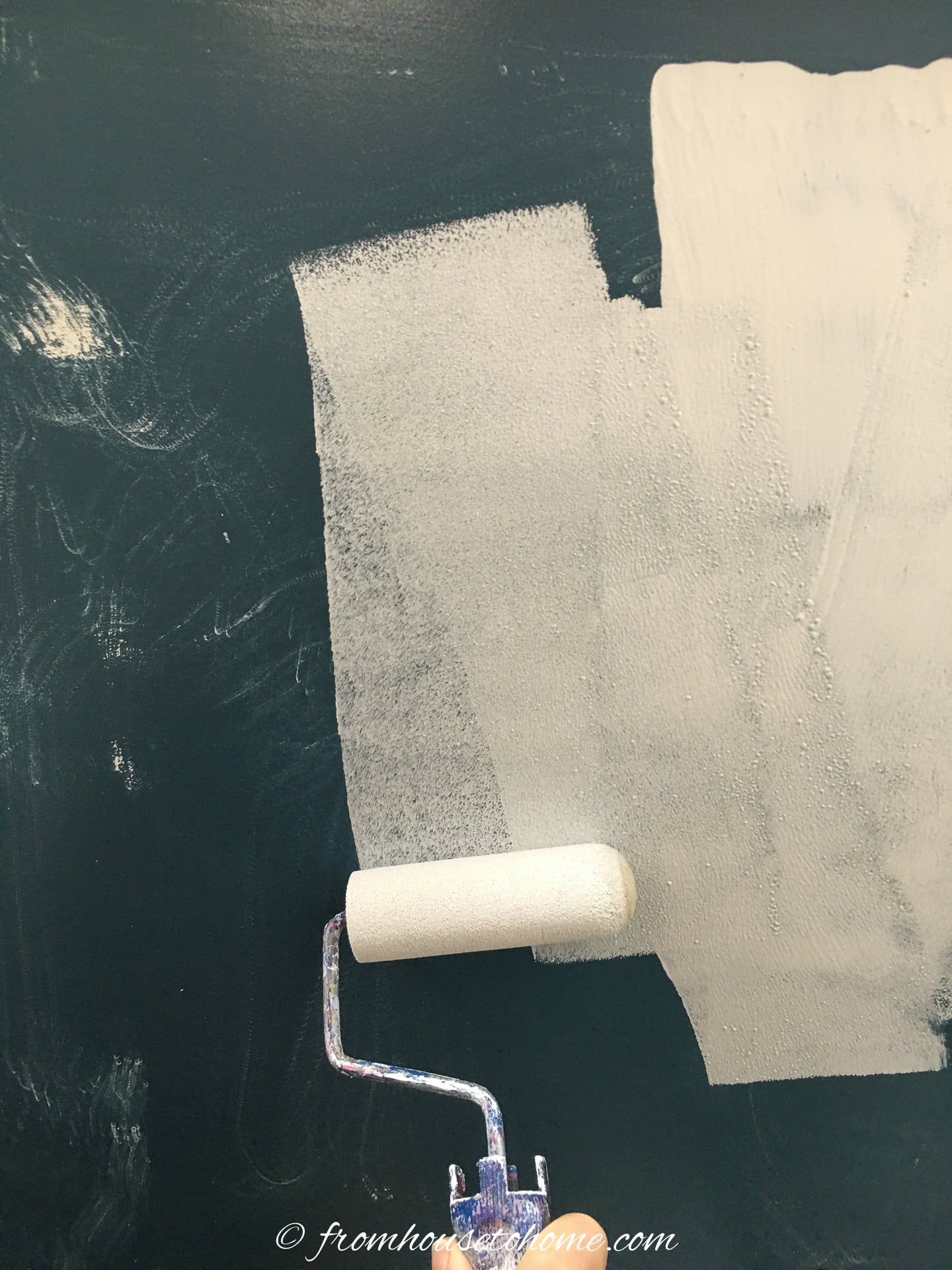 primer being rolled onto a painted surface