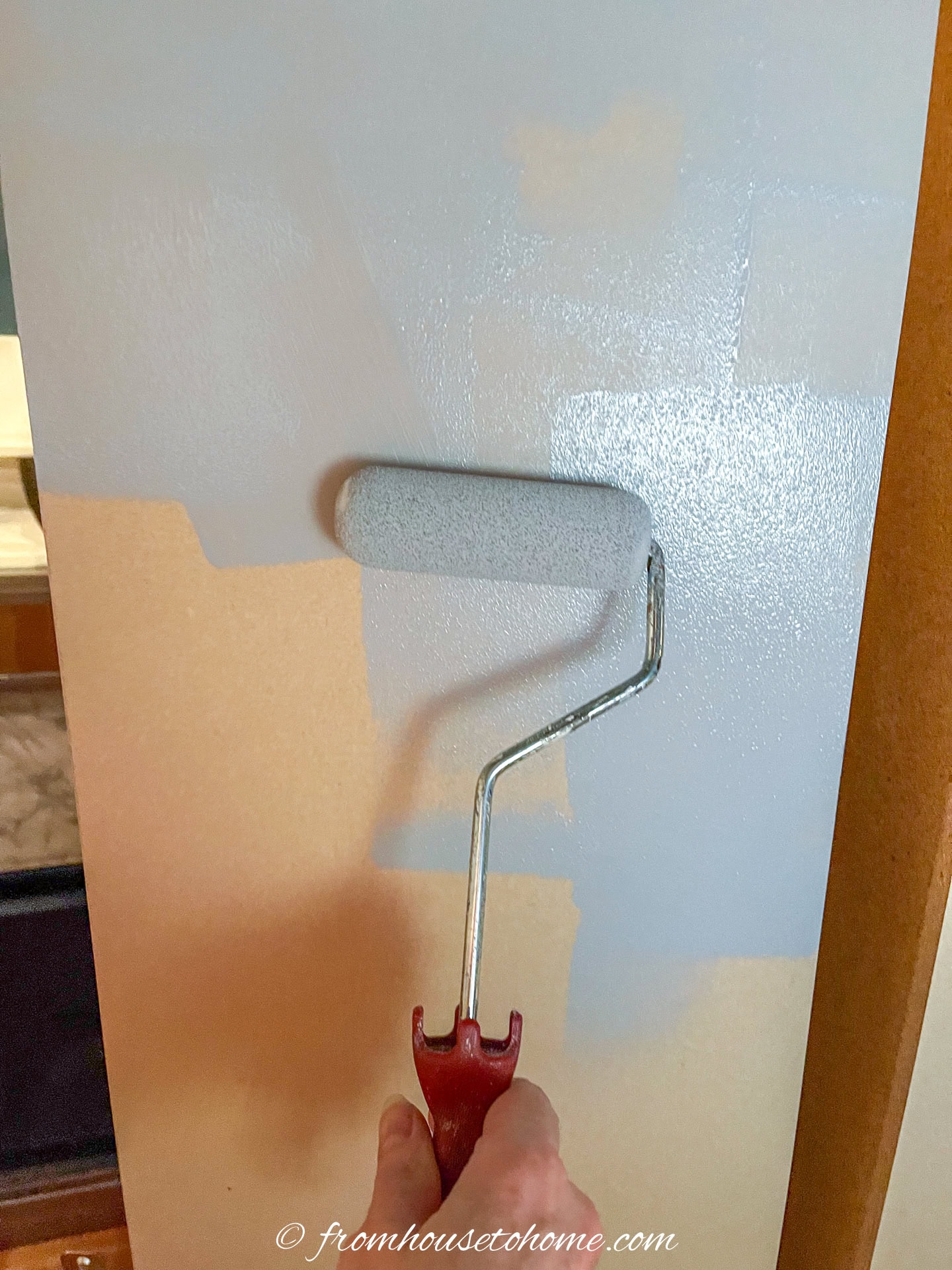 Primer being rolled onto an MDF shelf