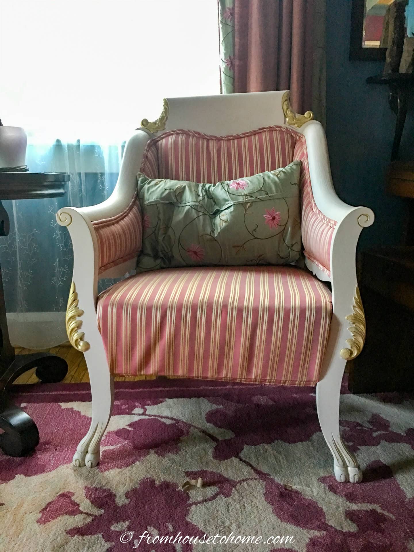 an antique chair painted with white and gold paint