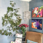 A wall Christmas tree beside a chair and table in a living room