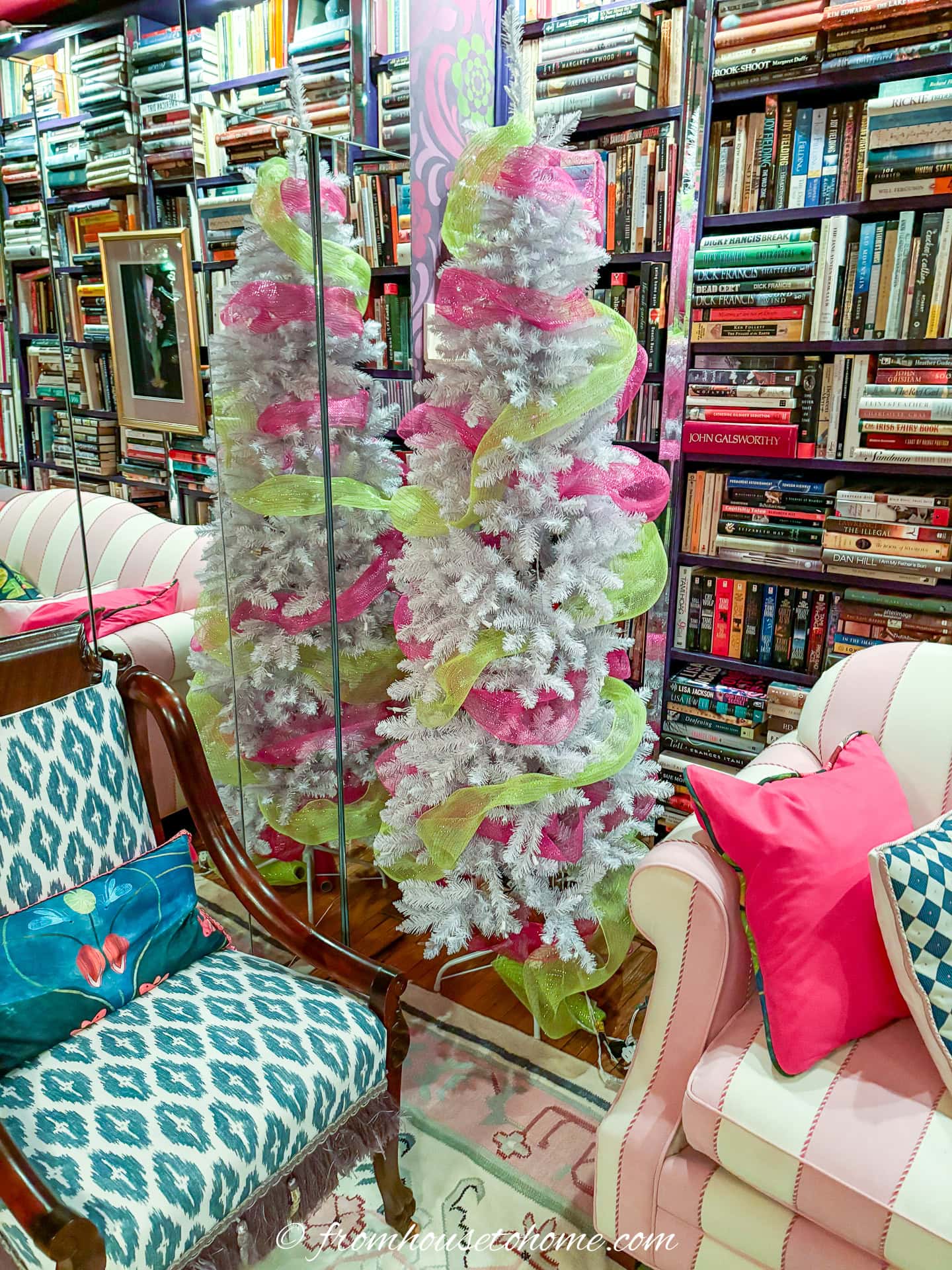 a white christmas tree wrapped with fuchsia pink and lime green deco mesh