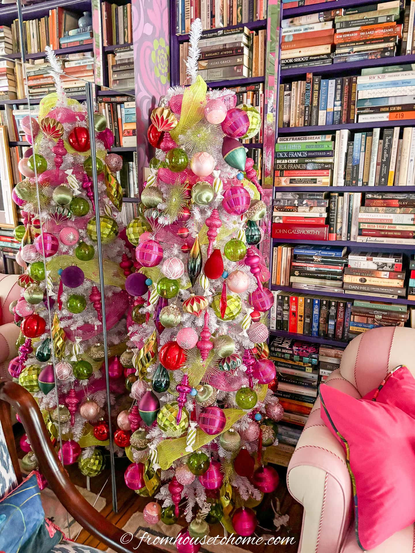 white christmas tree decorated with pink and green ball ornaments and finials