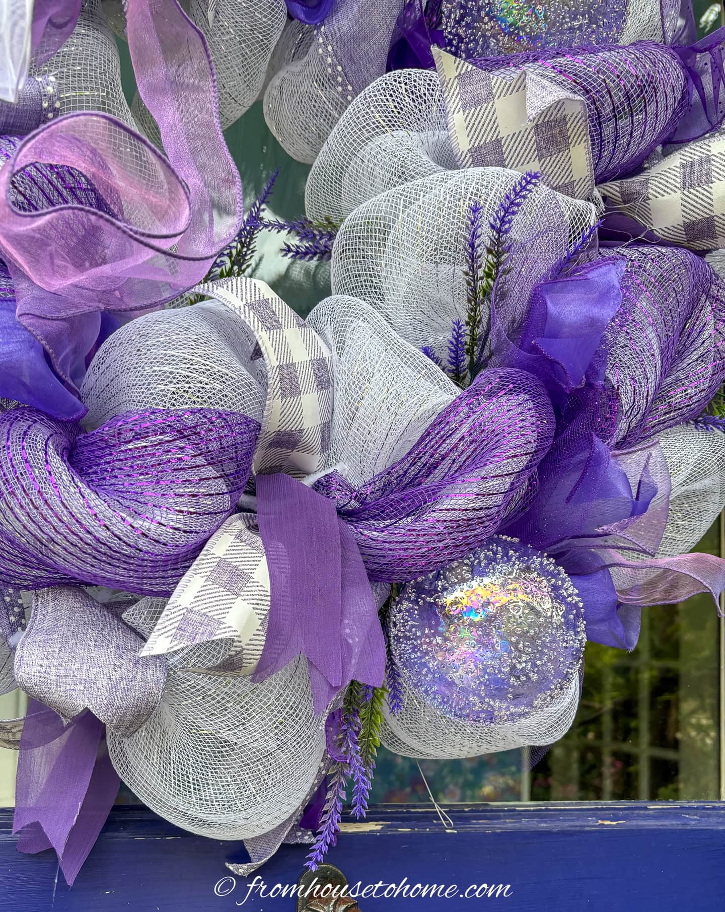 close up picture of the artificial lavender picks on a purple and white deco mesh wreath