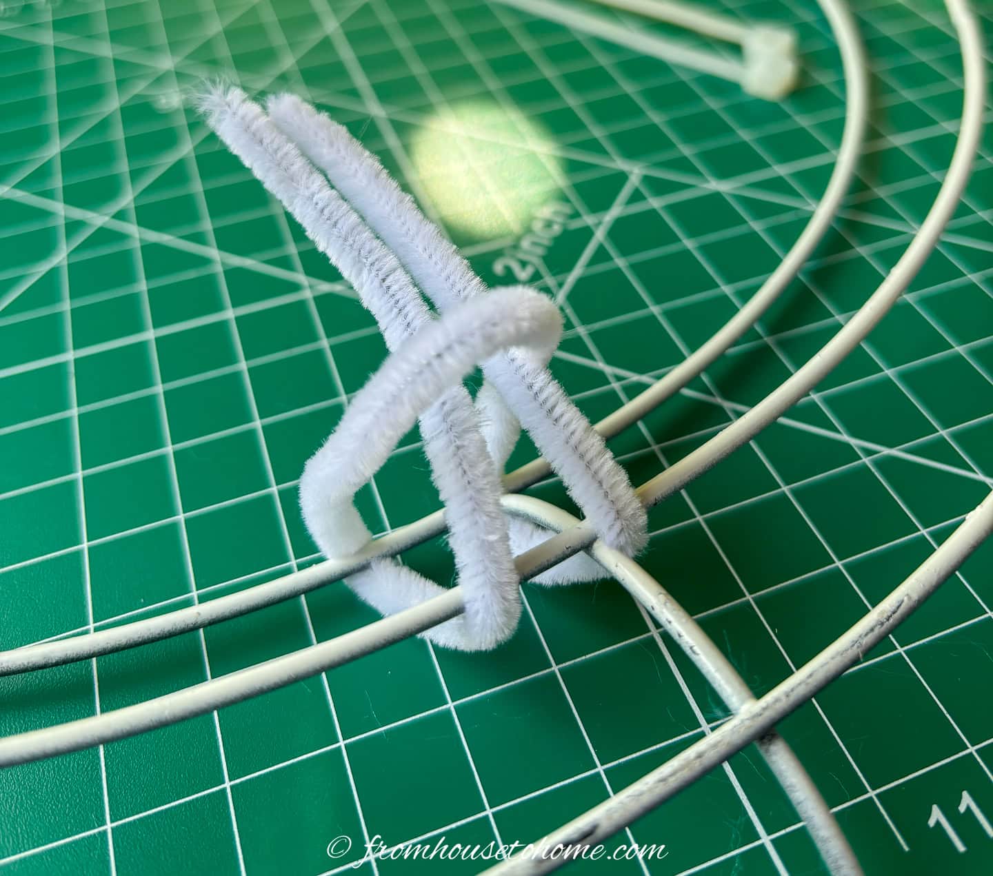 pipe cleaner looped around the inner rows of a wire wreath form