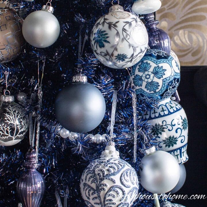 close up of blue and white ornaments on a Christmas tree