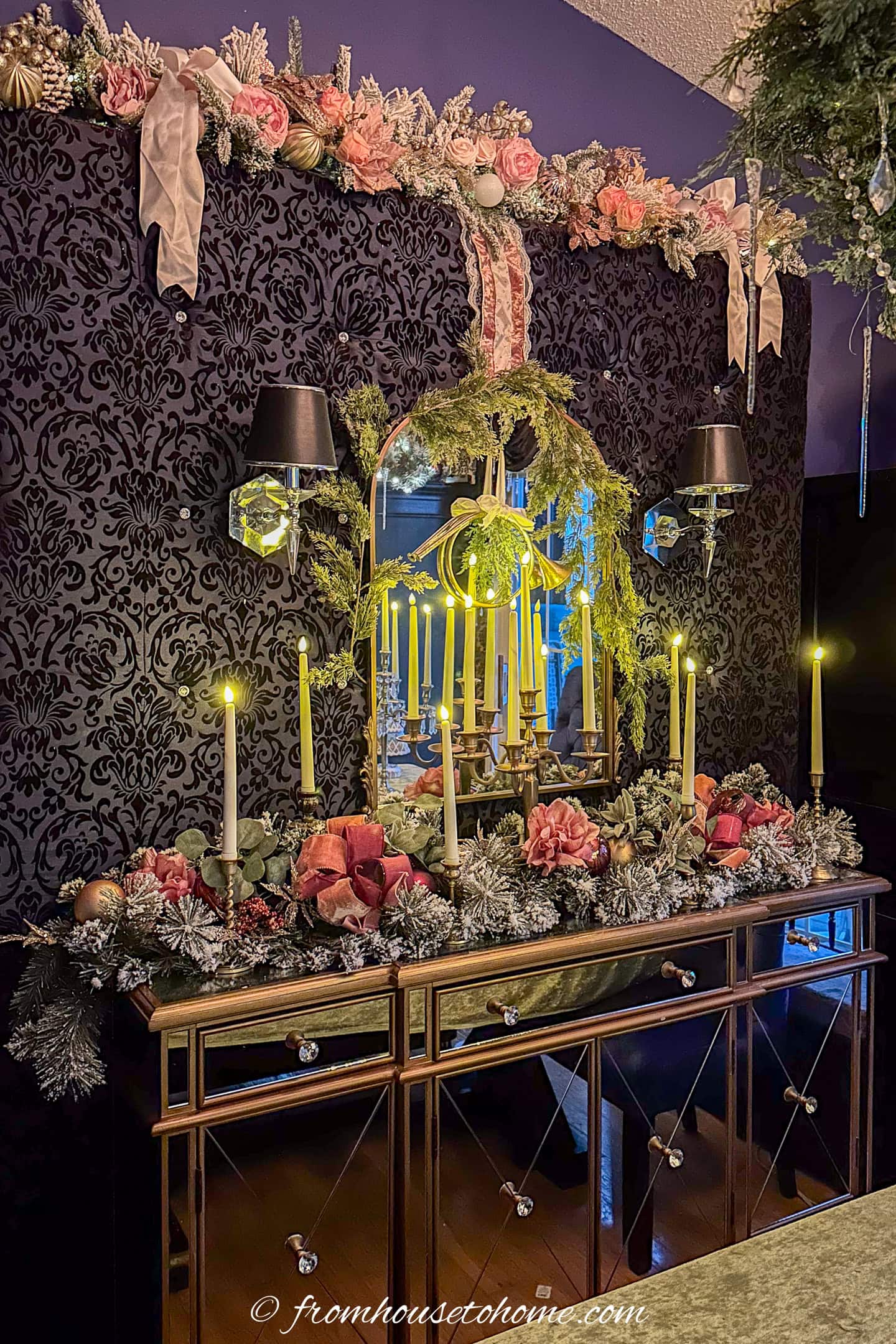A buffet table, mirror and backdrop decorated with Bridgerton-inspired garland