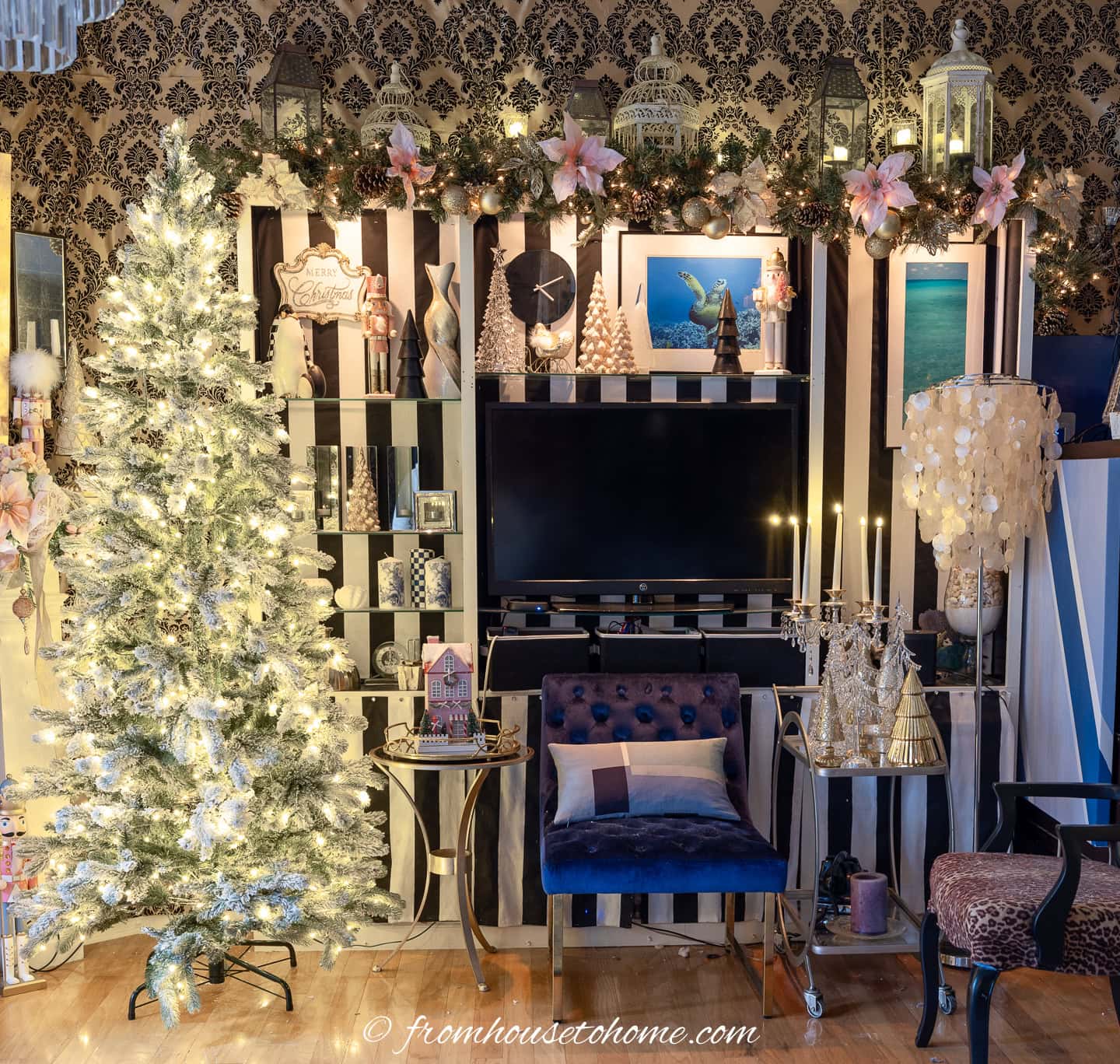 A bookshelf decorated for Christmas with a garland and nutcrackers