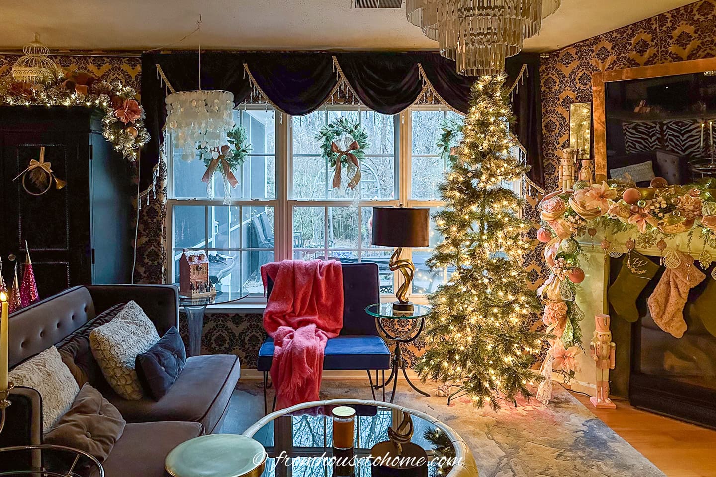 A living room decorated in pink and gold Bridgerton-inspired Christmas decorations