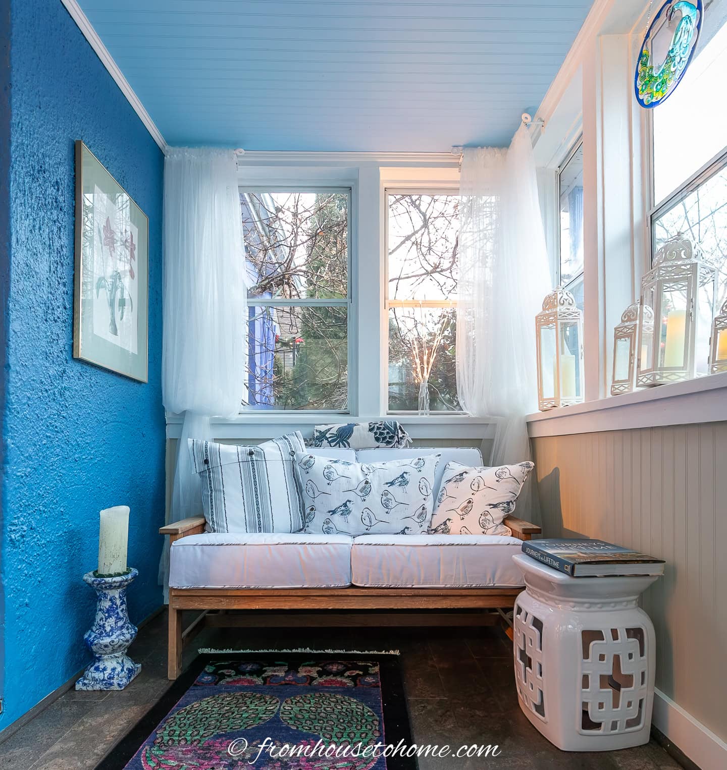 A front porch with a light blue beadboard ceiling