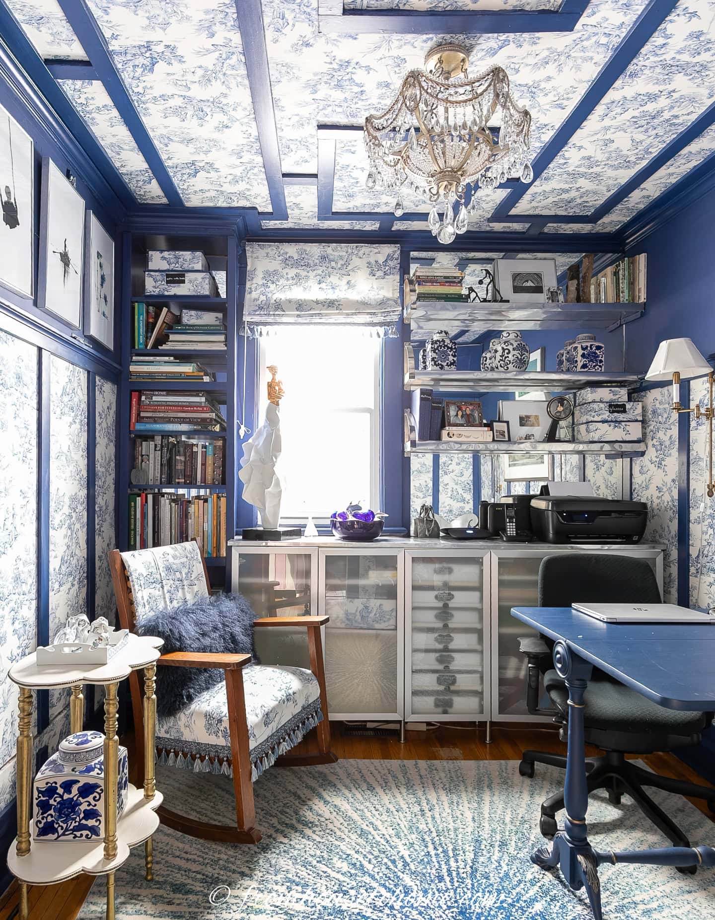 A blue and white home office with toile fabric hung on the ceiling and walls like wallpaper