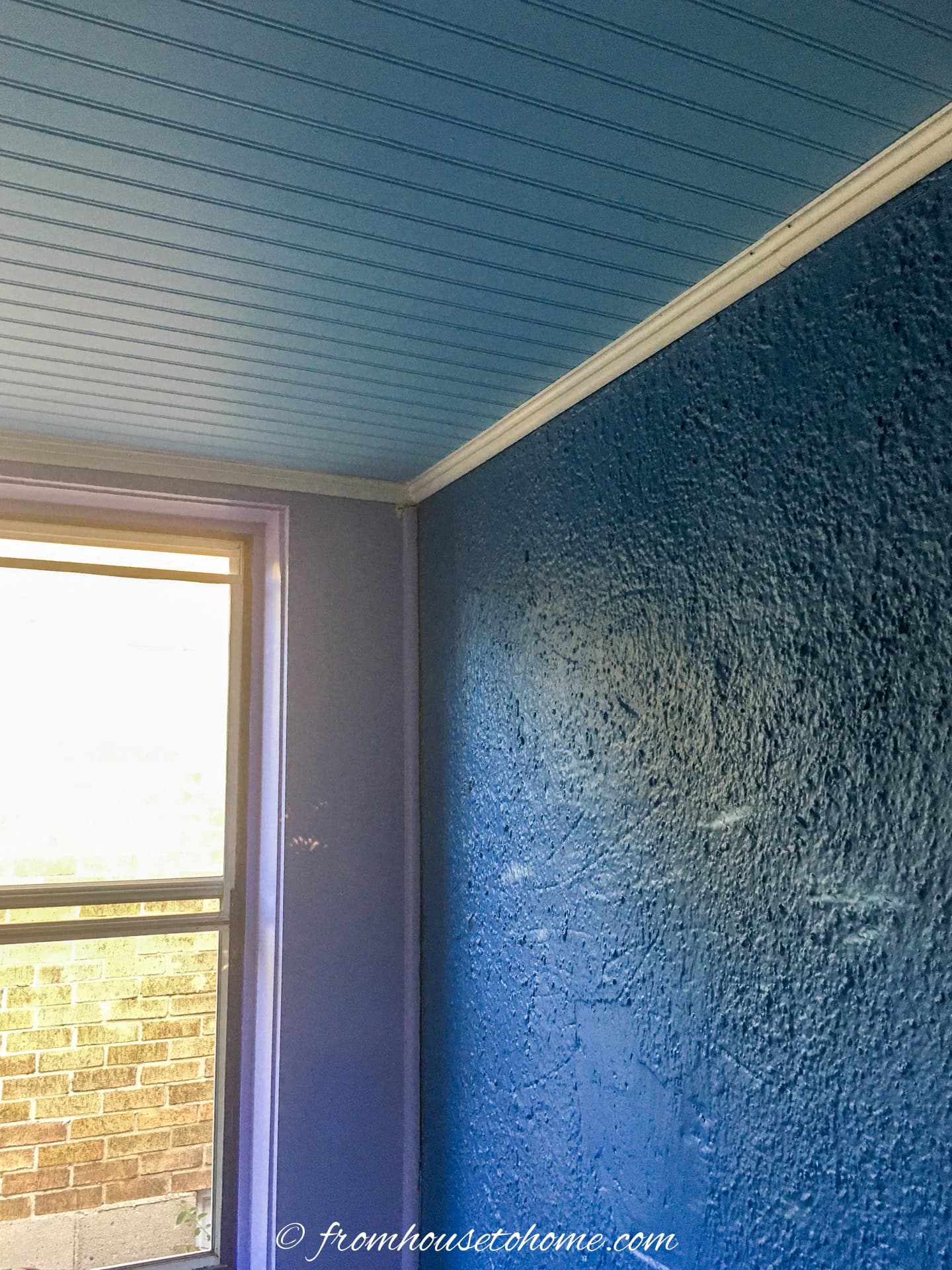 close up of blue beadboard on the ceiling with white crown molding