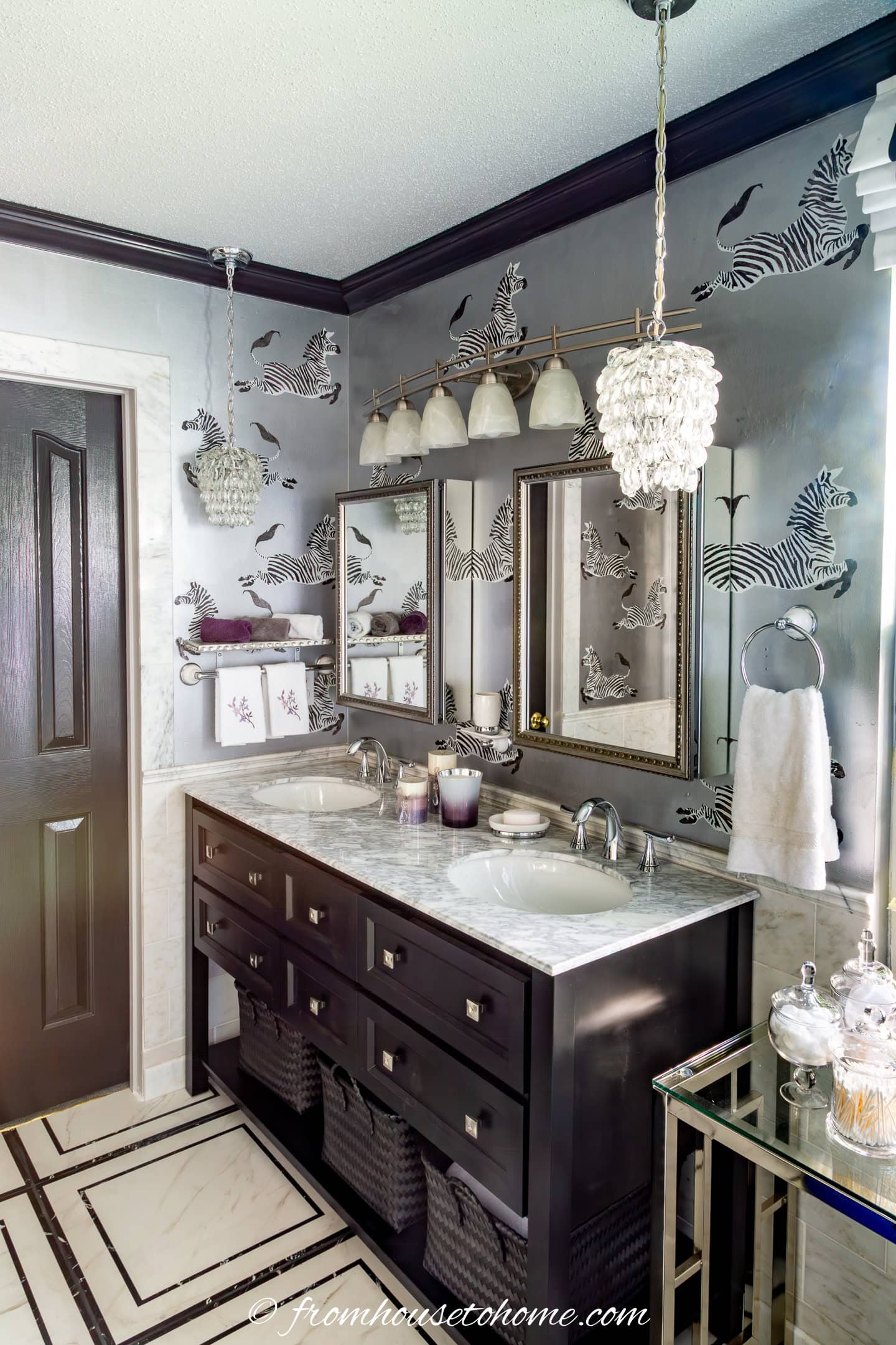Art Deco style bathroom with marble-top vanity, black and white floor tile and zebras stneciled on the wall