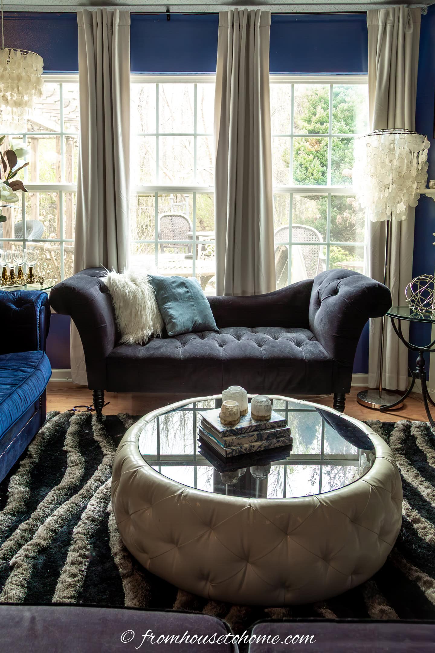 An Art Deco inspired round white leather and black coffee table in a living room