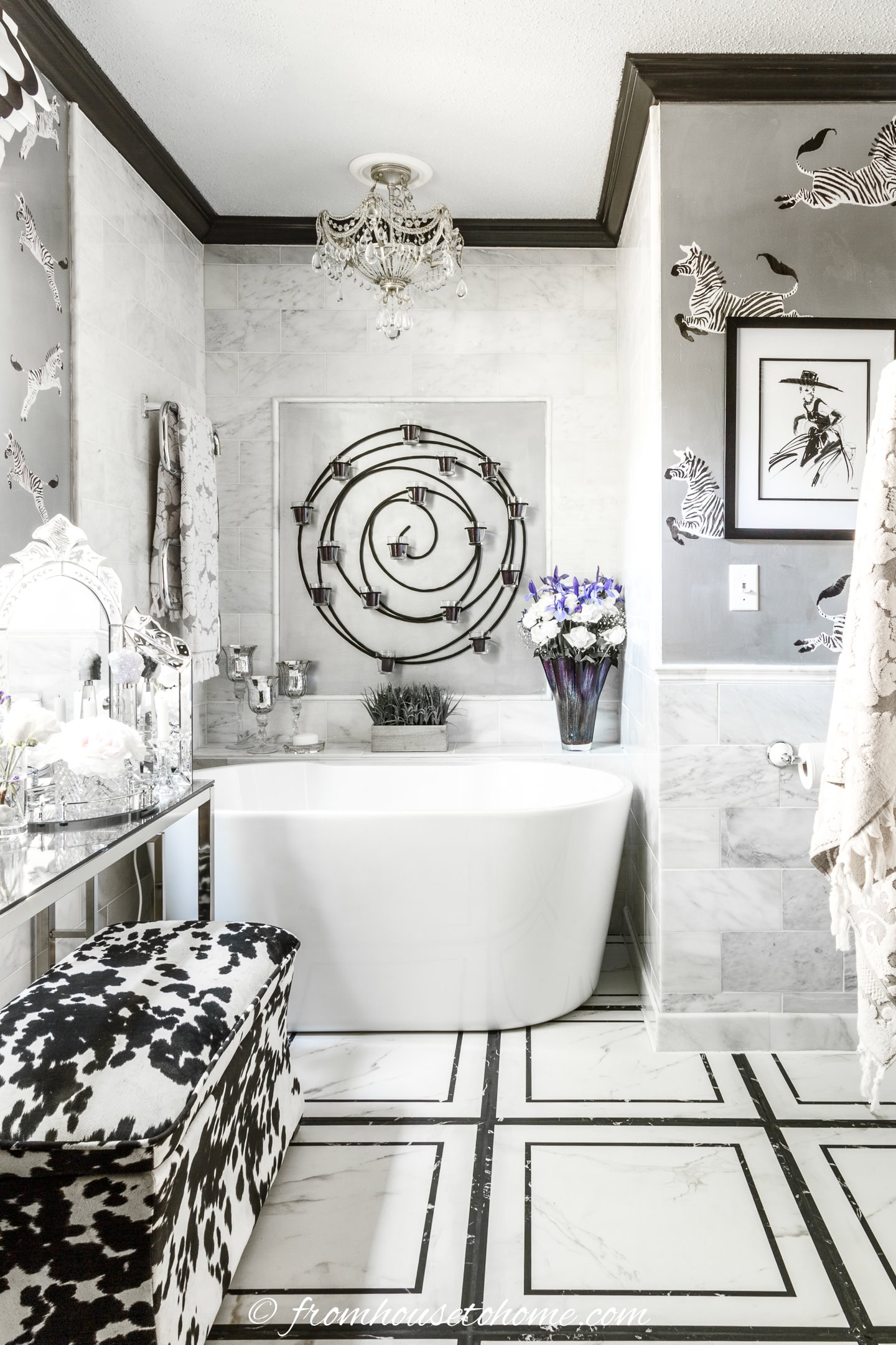 An art deco style bathroom with black and white geometric floor tiles and black crown molding