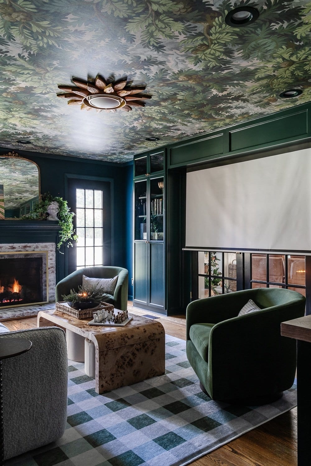 A starburst light fixture in a green media room