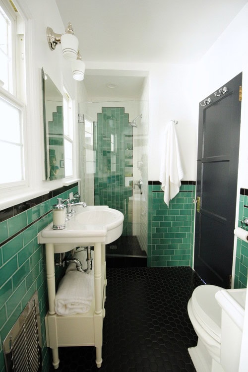A green and white Art Deco bathroom with geometric tile design
