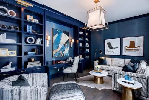 A desk built in to a library wall in a blue and white home office