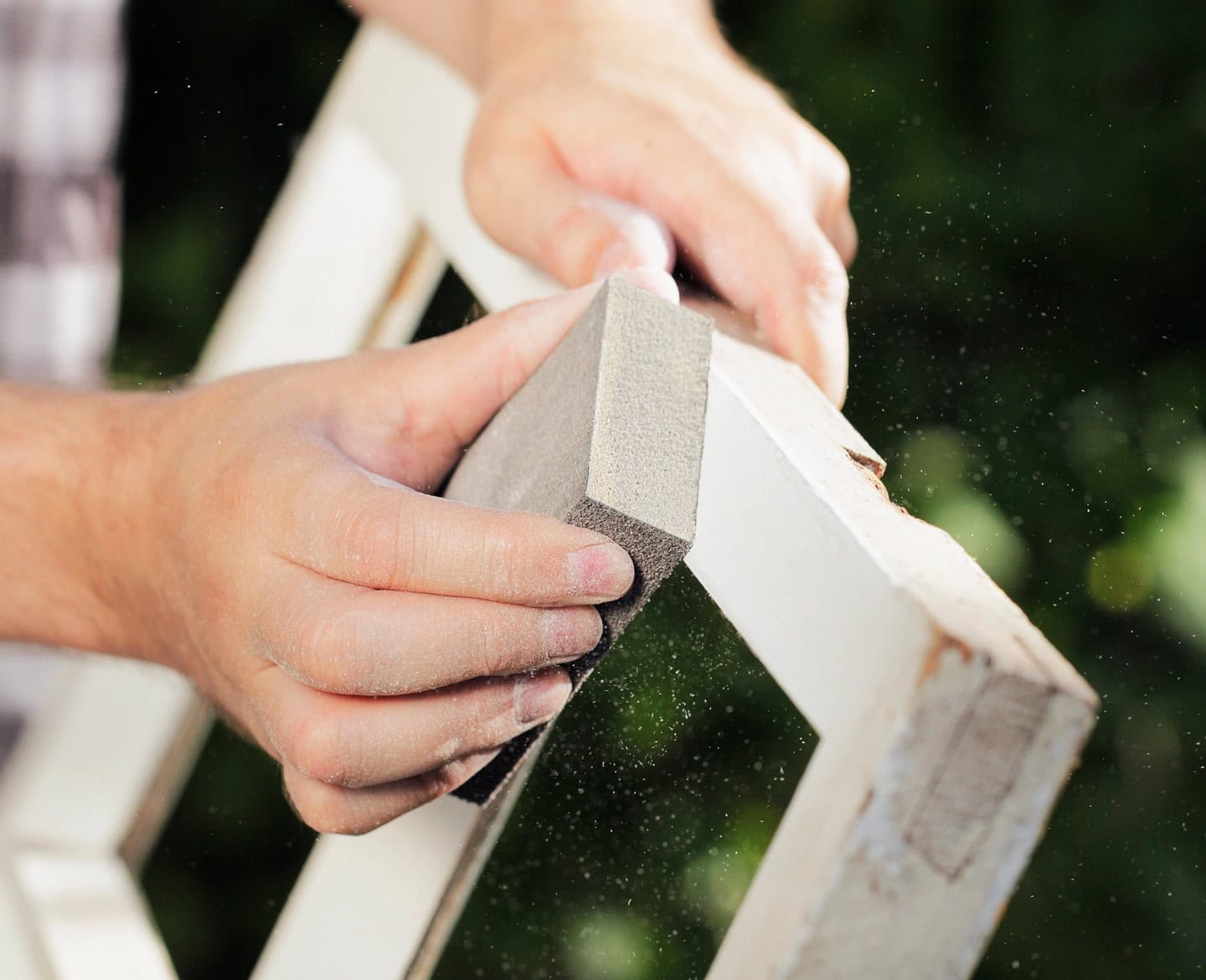 A window frame being sanded