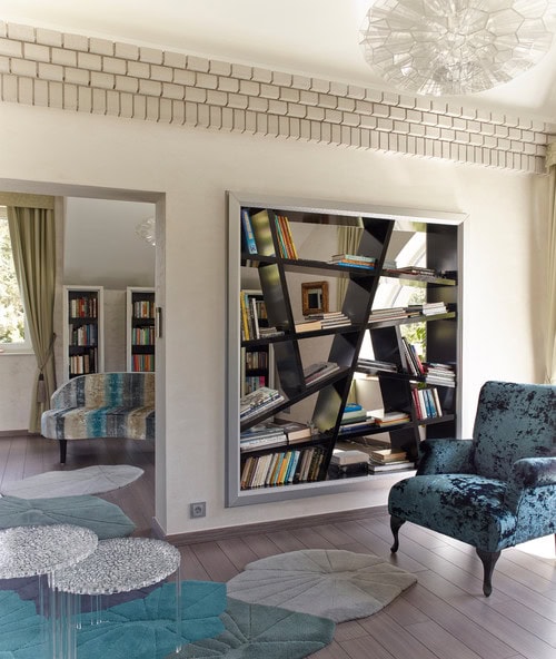 A bookshelf used as a wall divider in a living room