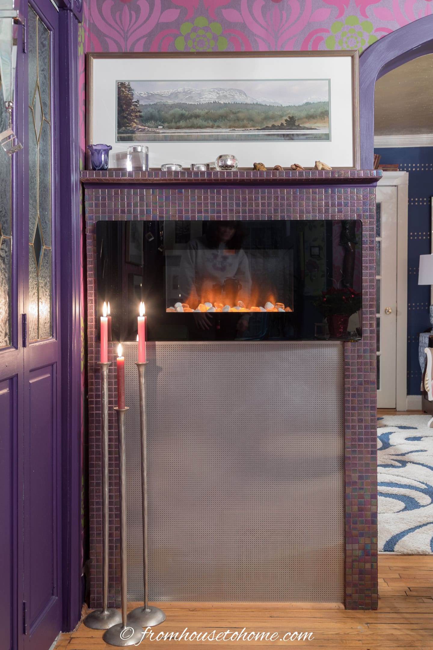 An electric fireplace installed on a wall in a small living room