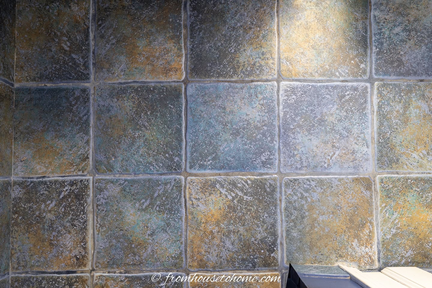 Slate-look ceramic tiles on the floor of a small bathroom