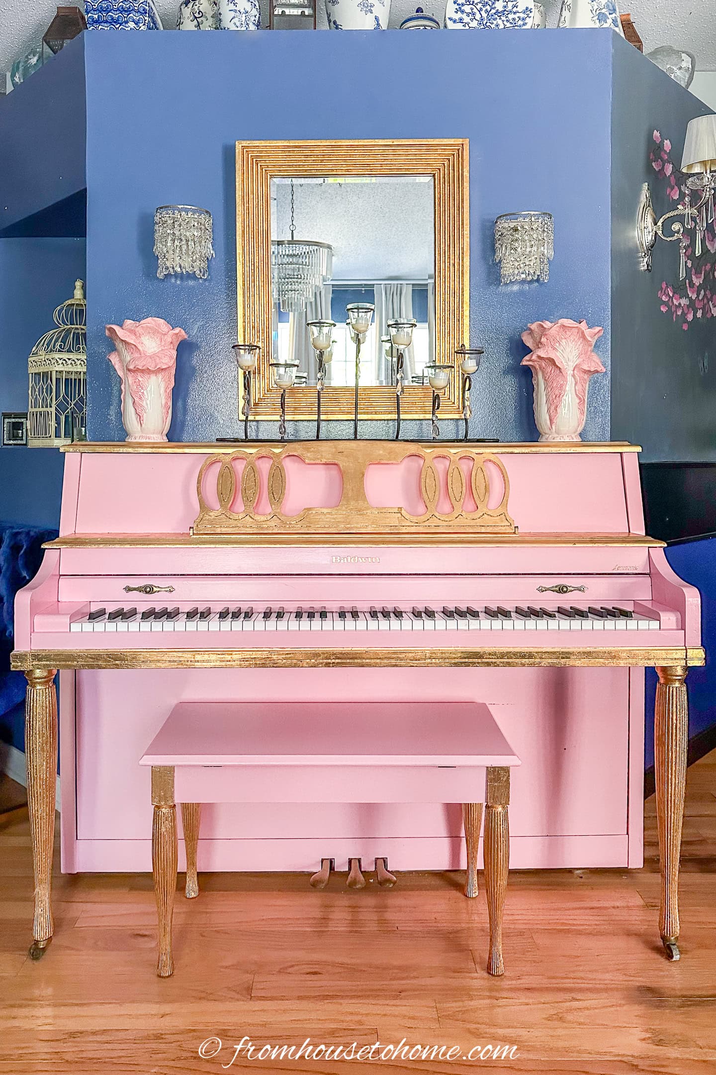 a pink piano against a blue wall