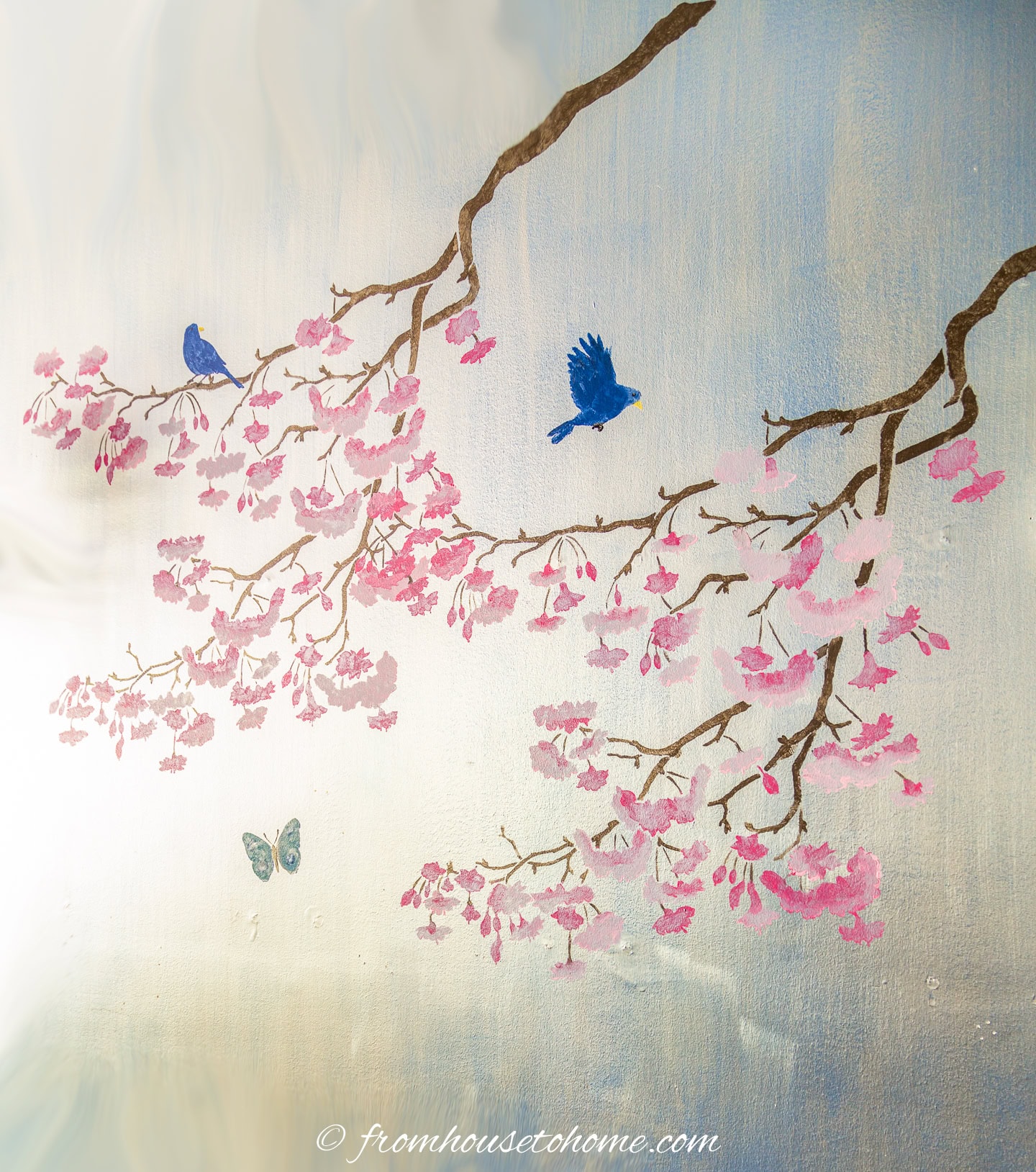 A DIY Chinoiserie cherry blossom stencil painted on a silver wall